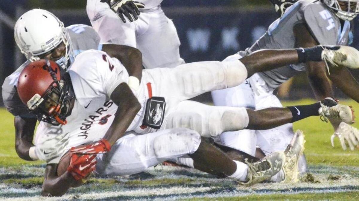 Ridgeland-Hardeeville ballcarrier Davontay Dopson is brought down by Hilton Head Island High School’s Taj Hamilton during their game on Sept. 23.