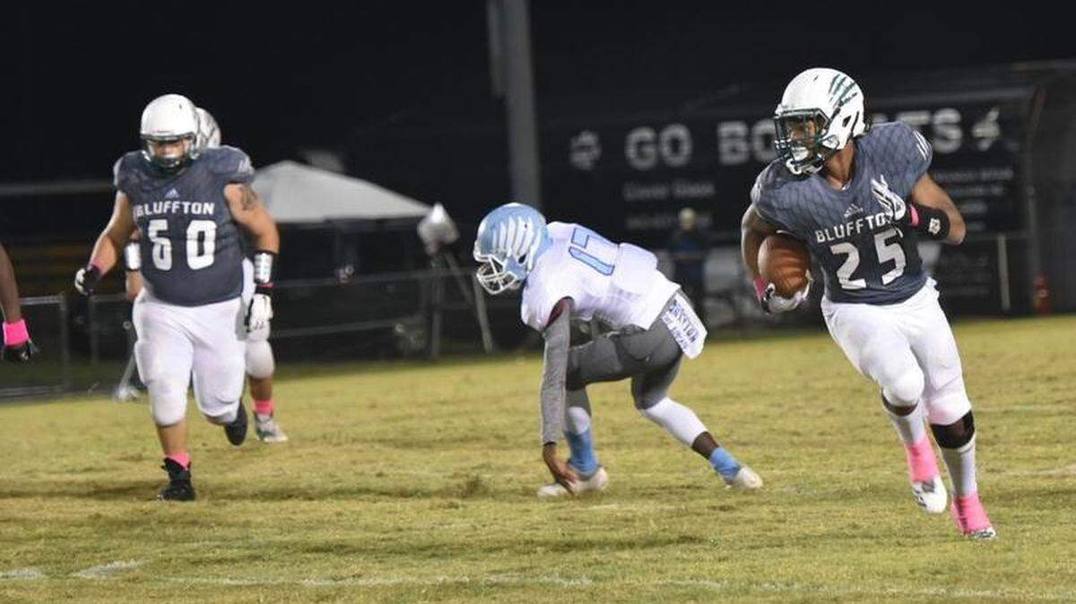 On 4th and inches, Bluffton running back John Swinton breaks free for a 28-yard run to to set the Bobcats up for the first points of the night vs Hilton Head in the Bridge Bowl on Friday night.