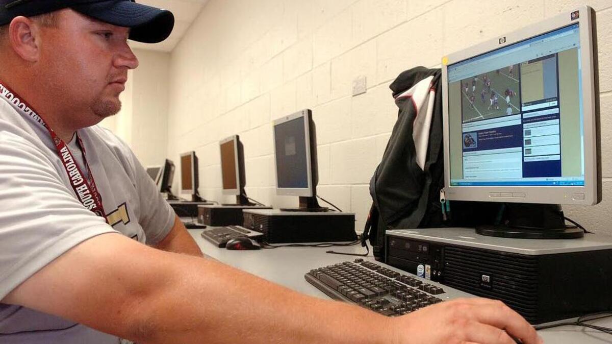 Battery Creek football coach Jim Shuman demonstrates the online video service he uses to watch game film. Shuman stepped down last week in order to spend more time caring for his ailing parents.