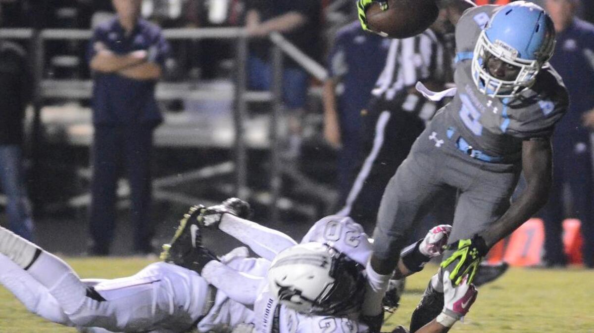 Hilton Head ball carrier Tyler Hamilton teeters in for a touchdown during last year’s Bridge Bowl contest against Bluffton.