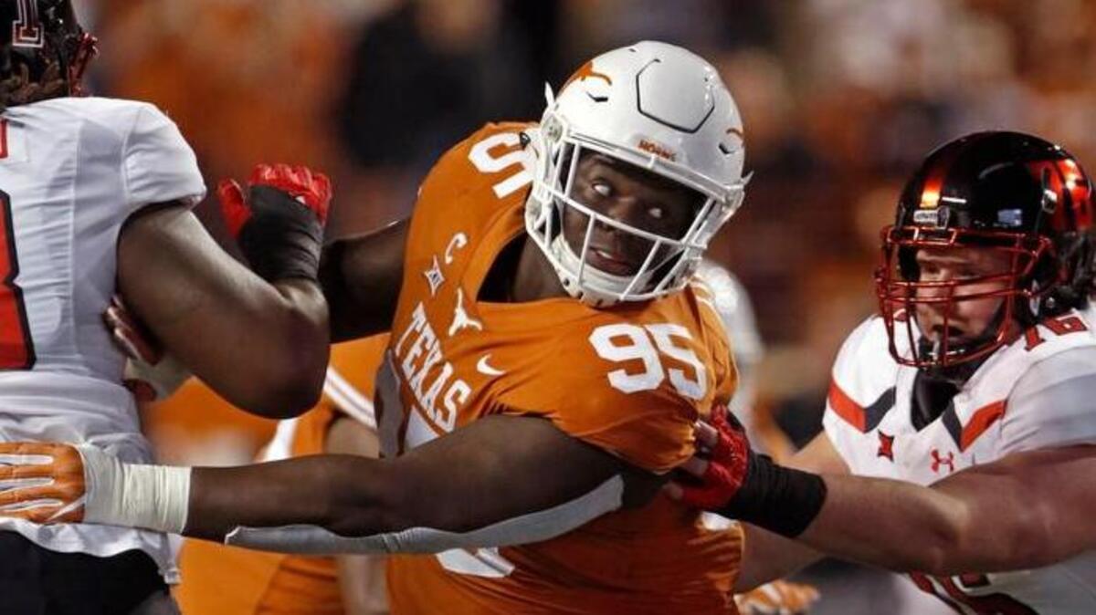 Texas defensive lineman Poona Ford (95) rushes during the first half of an NCAA college football game against Texas Tech on Nov. 24 in Austin, Texas.