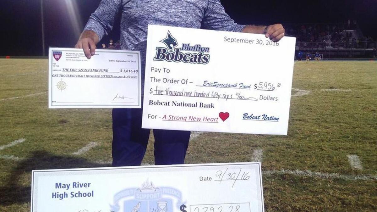 Steven Szczepanik, brother of Bluffton teen Eric Szczepanik, holds checks for funds raised by Bluffton High, May River and Hilton Head Prep toward Eric’s pending heart transplant. Bluffton and May River competed last week to outraise the other.