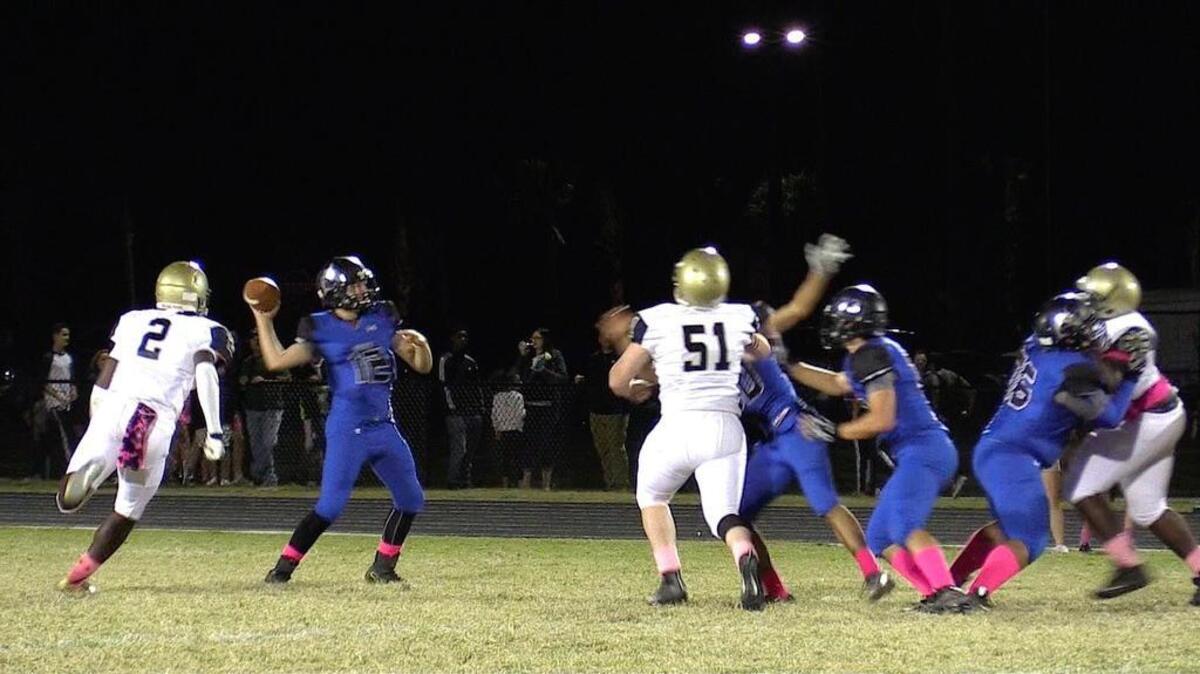 May River quarterback Joseph Tapscott gets a pass off as Battery Creek linebacker Eddie Dean closes in during the Oct. 21 game.