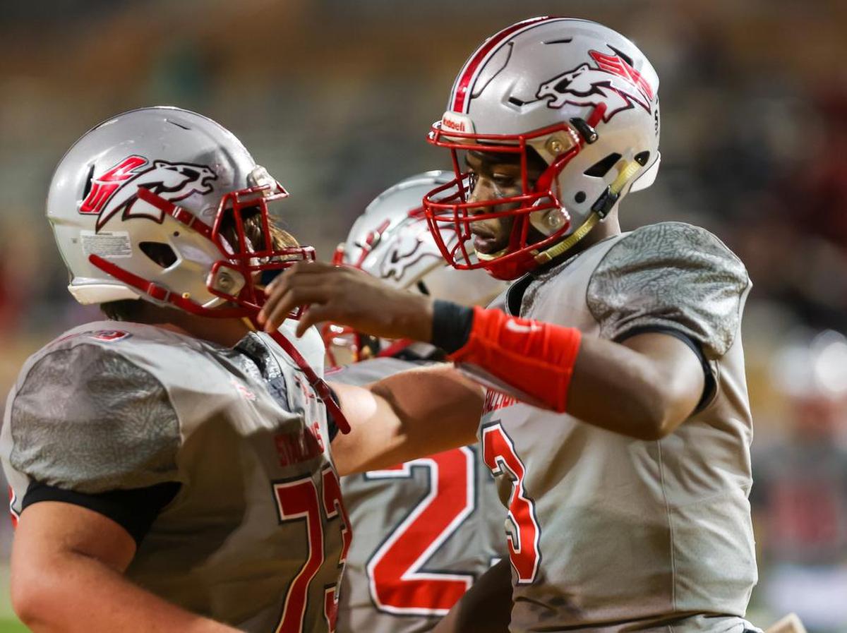 South Pointe Stallions quarterback Zavieon McCrorey (3) and South Pointe offensive lineman Cam Wilson (73) celebrate a touchdown against the Beaufort Eagles in the Class 4A SC State Championship Game at Benedict College in Columbia, SC, Thursday night, December 2, 2021.