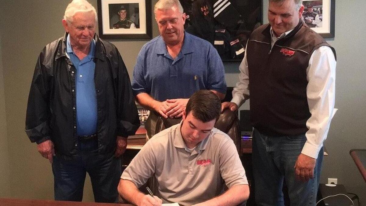 Flanked by his grandfather and father, Bluffton driver Gus Dean signs his sponsorship agreement with GREE that begins with next year’s ARCA series. Also looking on is Tradewinds Climate Systems president Dave Pearson, top center.