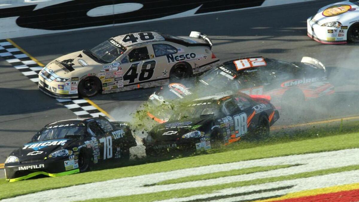 Bluffton’s Gus Dean (98) slides onto the infield after making contact with teammate Cole Powell (78) as part of a nine-car wreck just three laps into Saturday’s ARCA race at Daytona International Speedway.