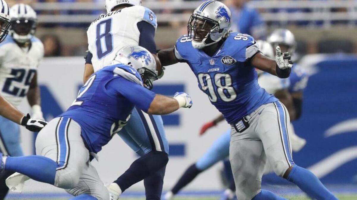 Detroit Lions Halooti Ngata and Devin Taylor sack Tennessee Titans quarterback Marcus Mariota during second quarter action on Sunday, Sept. 18, 2016 at Ford Field in Detroit, Mich.