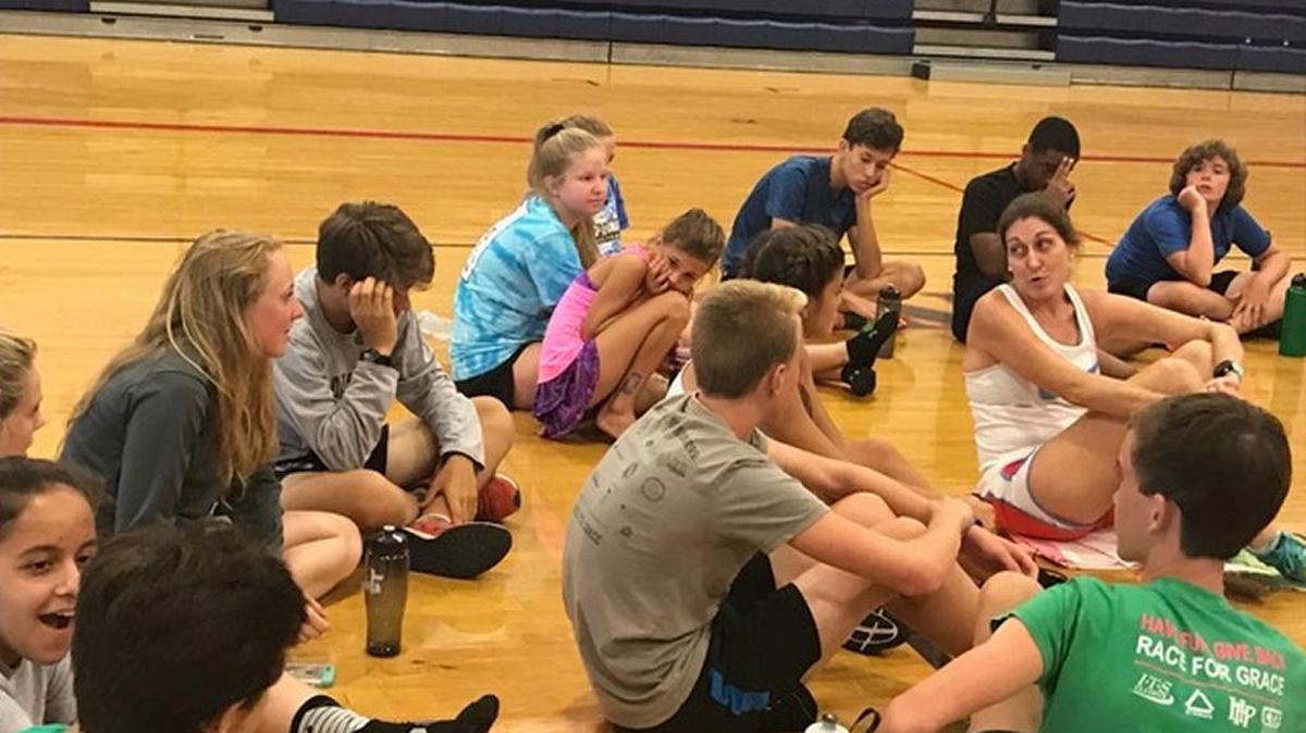Dana House, right, speaks with a few of the participants in the second annual Runners Camp at Hilton Head Preparatory School.