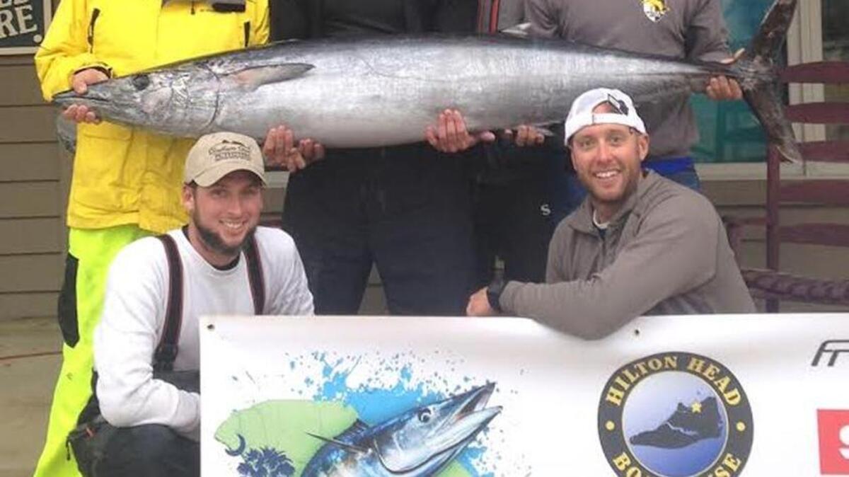 Team Tuna Hut poses with its 102-pound wahoo.