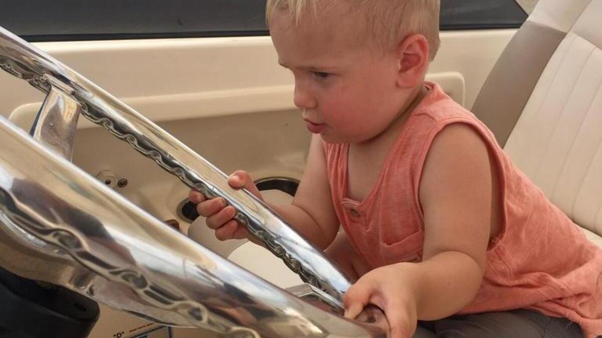 Fourteen-month old Benjamin takes a turn at the boat’s controls.