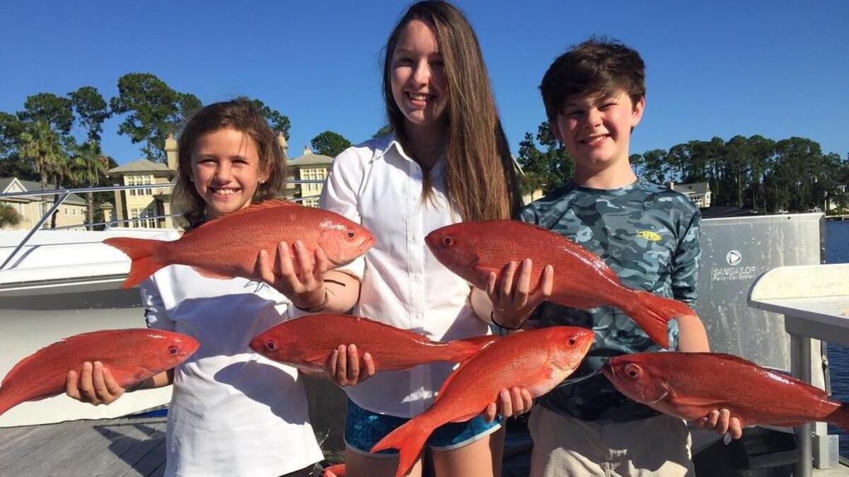 Caroline Bullock, Carlyle and Miller Cornell with big vermilion snapper.