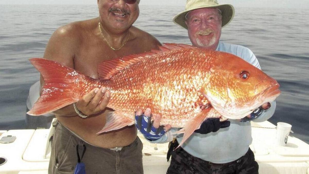 Harry Morales and Don McCarthy hold up a fine red snapper.