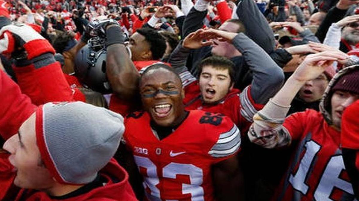 Ohio State players and fans celebrate their win over Michigan in an NCAA college football game Saturday, Nov. 26, 2016, in Columbus, Ohio. Ohio State beat Michigan 30-27 in double overtime.