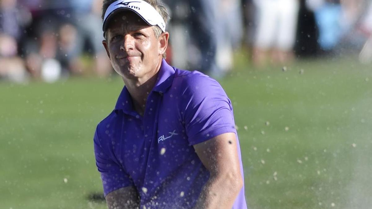 Luke Donald looks through the flying sand after hitting out of the greenside bunker on No. 18 during the final round of the 48th annual RBC Heritage Presented by Boeing golf tournament on Sunday, April 17, 2016 at Harbour Town Golf Links on Hilton Head Island, S.C. Donald, who led after three rounds, ended up in a tie for second place with Russell Knox, two strokes behind tournament champion Branden Grace.