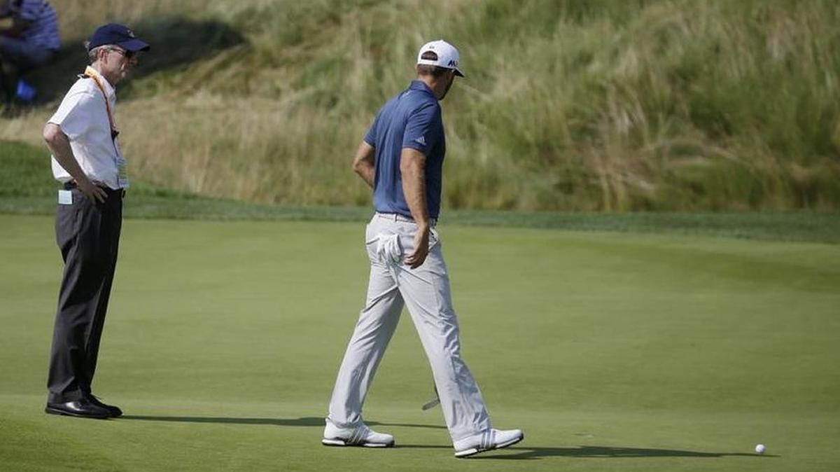 Dustin Johnson, right, talks to a rules official on the fifth green during the final round of the U.S. Open golf championship Sunday at Oakmont Country Club.