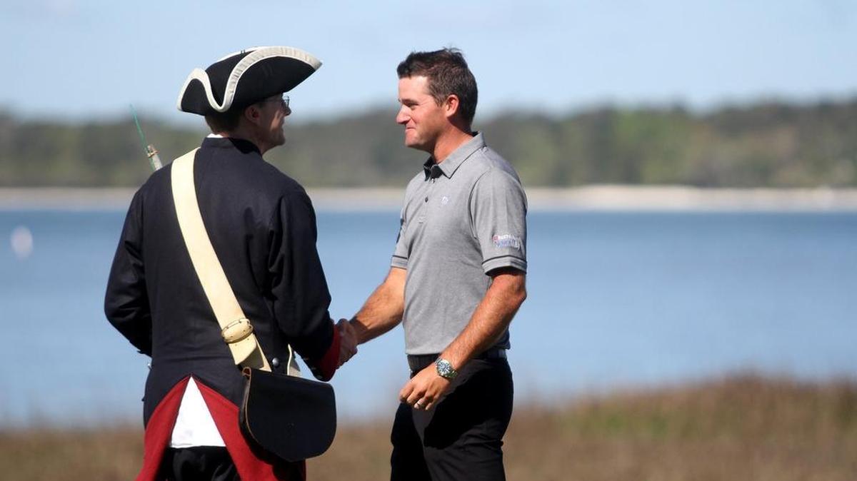 Sam Saunders, grandson of Arnold Palmer, shakes hands with one of the two cannoneers before honoring his late grandfather during the opening ceremony of the 49th RBC Heritage Presented by Boeing on Monday morning at the 18th green at Harbour Town Golf Links in Sea Pines on Hilton Head Island S.C.