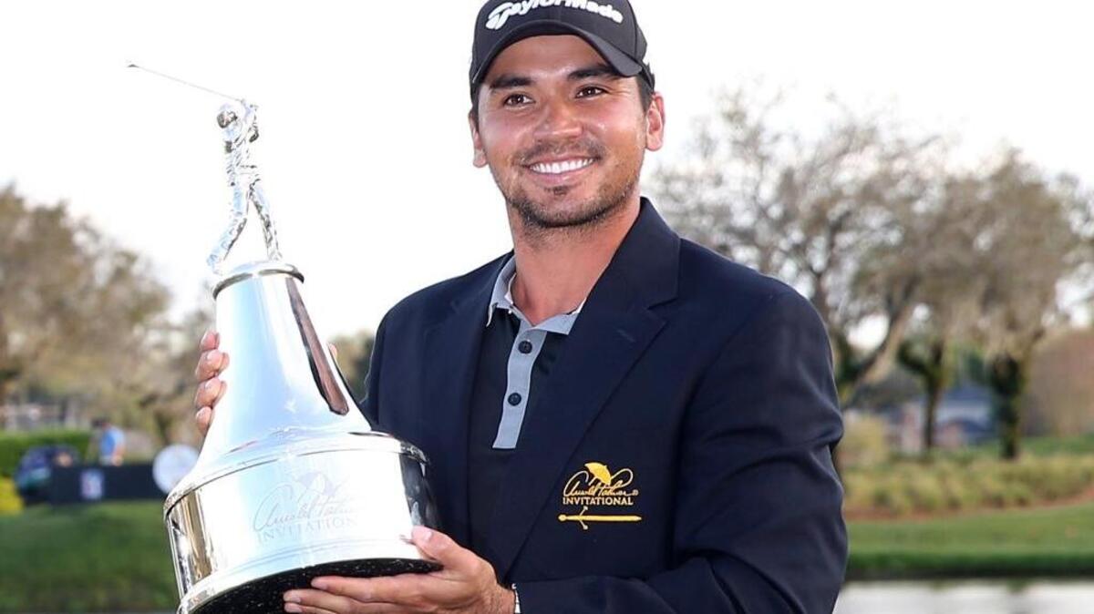 Australia’s Jason Day poses with the championship trophy after winning the Arnold Palmer Invitational Sunday in Orlando, Fla.