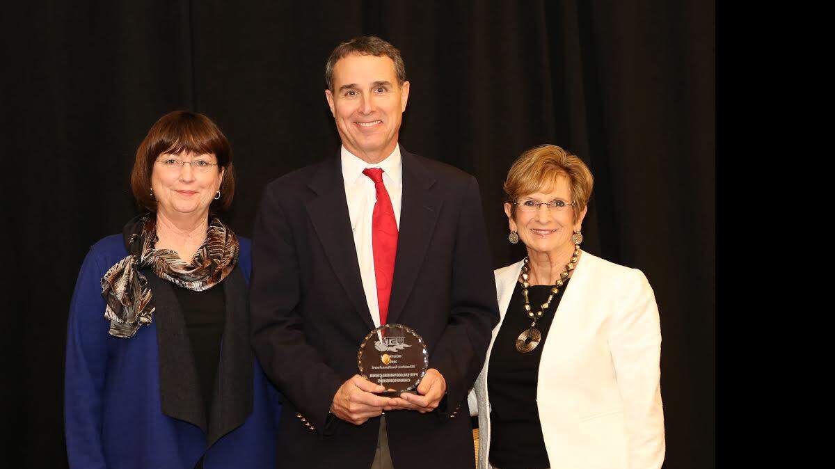 Professional Tennis Registry CEO Dan Santorum, center, accepted the Wheelchair Excellence Award from USTA Southern. Joining Santorum are USTA Southern Awards Committee Chairman Eleanora Mauritson, left, and USTA Southern President and CEO Paula Hale, right.