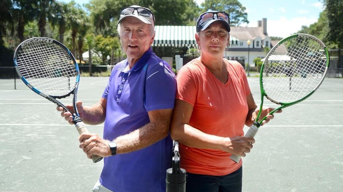 Gavin Cox, representing the Mainland team in the Tennis Bridge Bowl, stands for a portrait with Jackie Reynecke, representing the Island team, on Aug. 16, 2016, on the tennis courts in Colleton River Plantation in Bluffton.